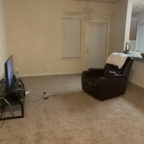 Armchair and TV in an empty room